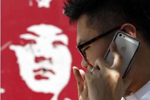 File picture shows a man talking on an iPhone in Beijing