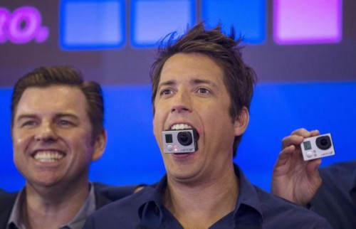 GoPro Inc's founder and CEO Woodman holds a GoPro camera at the Nasdaq Market Site in New York City