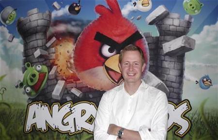 Rovio PHK Ratusan Karyawannya 2 Rovio Chief Executive Mikael Hed stands in front of an Angry Birds poster at his company's offices in Helsinki