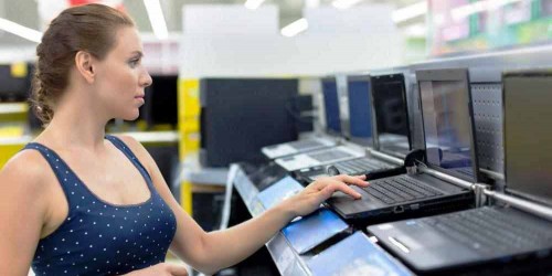 woman-looking-at-laptops-in-store